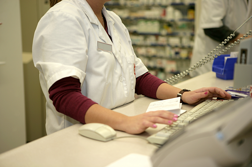 Pharmacist using a computer