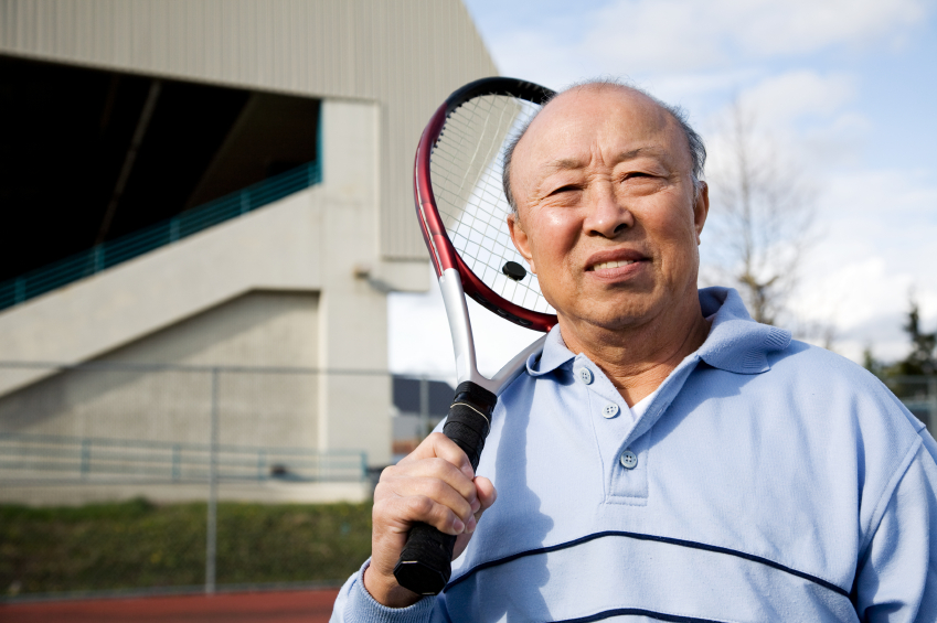 older Asian man with tennis racket